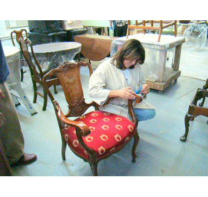 Master craftsperson restoring antique chair