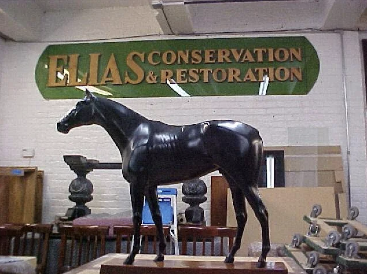 Antique horse statue in restoration workshop